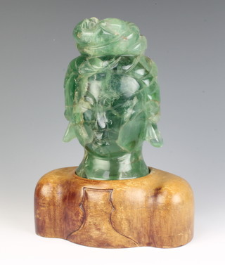 A carved green quartz bust of a lady 19cm raised on a carved hardwood half torso 