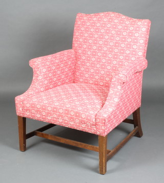 A Georgian style mahogany library chair upholstered in red and white floral material raised on square tapered supports with H framed stretcher 