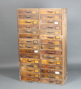 A 19th Century pine range of 30 short drawers with iron handles, raised on a platform base 146cm h x 91cm x 35cm 