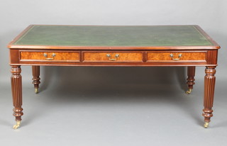 A Georgian style mahogany library table with inset writing surface above 6 long drawers, raised on turned and reeded supports, brass caps and casters 77cm h x 183cm w x 106cm d 