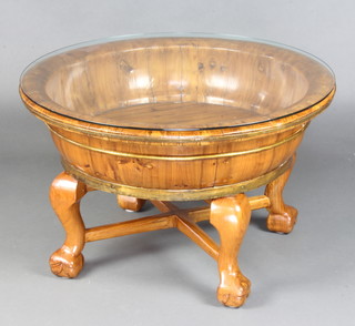A Chinese hardwood circular baby's bath converted for use as a coffee table, raised on cabriole supports with X framed stretcher and plate glass top 50cm x 77cm diam. 
