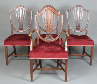 A set of 4 19th Century Hepplewhite style shield back dining chairs with over stuffed seats, raised on square tapered supports with H framed stretcher, comprising a carver and 3 standard chairs