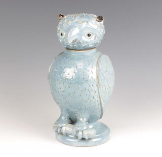 An early 20th Century studio pottery ewer and cover in the form of an owl sitting on a trunk, raised on a circular base 25cm 