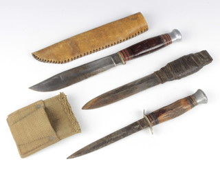 Wade and Butcher, a bowie style knife, the blade marked Pioneer with 17cm blade and scabbard, a William Rodgers double bladed knife with 14.5cm blade and horn grip, a double bladed fighting knife with 15cm blade and webbing frog 