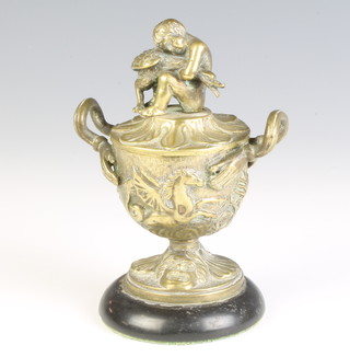 After the antique, a Regency gilt bronze inkwell in the form of a twin handled classical urn, the lid decorated a boy holding a goose, raised on a marble base 11cm x 5cm diam., together with an associated china liner (f) 
