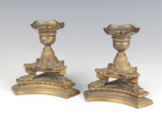 A pair of Regency style stub bronze candlesticks raised on triform bases 13cm x 10cm x 12cm 