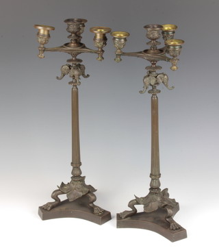 A pair of Regency style bronze 5 light candelabrum with elephant decoration raised on fluted columns and triform base 47cm x 13cm x 18cm, 