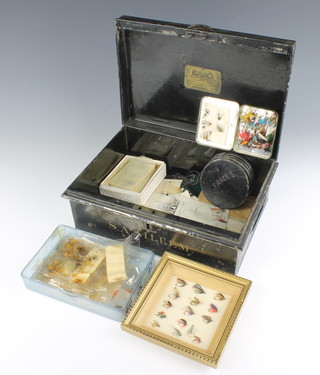 A Hepburn Adcock metal deed box containing a rare J Peak cast tin, a Richard Wheatley Loch Leven fly box, packs of Wheatley fishing flies and a framed arrangement of 15 flies 