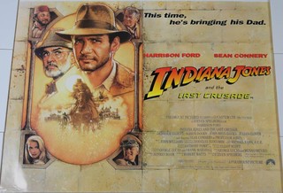 Various late 20th Century movie posters to include "Indiana Jones and the Last Crusade",  "Romancing the Stone", "Young Sherlock Holmes","The Philadelphia Experiment" and "The Odessa File",
