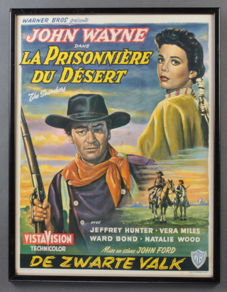 A Belgian movie poster for the John Wayne Film "The Searchers" ( La Prisonniere Du Desert ), framed 36 w x 47.5 h ( approx )