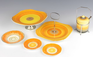 An Art Deco Shelley preserve pot and cover in a plated stand with spoon, a cake stand, tazza and 3 saucers 