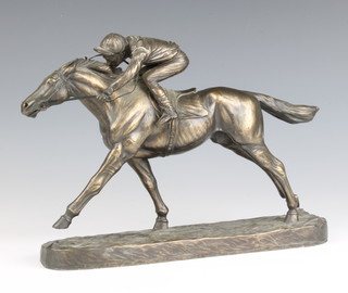 A bronzed figure of a race horse with jockey up, raised on an oval base 20cm h x 28cm w x 7cm d (jockey's hand f) 