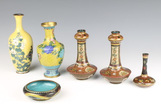 A Japanese yellow ground cloisonne enamelled vase with floral decoration 18cm (chipped and some crazing), a pair of bottle shaped vases 14cm (chips to rim), a yellow club shaped vase  16cm, a circular ashtray decorated a dragon and a club shaped specimen vase 9cm 