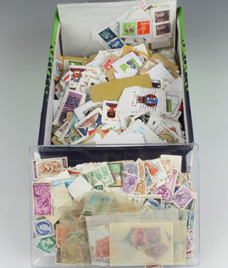 Two boxes containing a quantity of world stamps 
