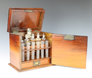 A Victorian mahogany apothecaries cabinet, the upper section containing a glass spirit burner, 5 glass bottles and stoppers, 6 test tubes, the base fitted a drawer containing a small ivory magnifying glass etc 28cm h x 28cm x 19cm 