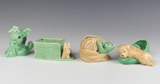 A Sylvac green figure of a terrier 1119 9cm, a ditto vase in the form of a terrier standing by a wicker basket 2054 11cm, another of a terrier sitting across a slipper 31 15cm and a kitten emerging from a ball of string 3183 7cm 