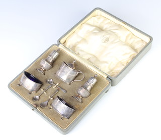 A silver 5 piece condiment set and 3 spoons with chased urns and swags, Birmingham 1946, cased, 120 grams