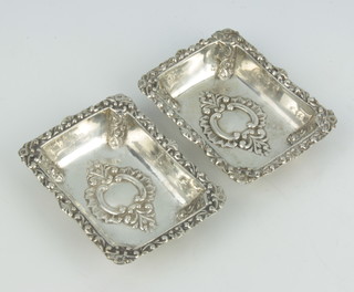 A pair of Continental 800 standard silver repousse rectangular dishes with scroll decoration  10.5cm x 8cm, 177 grams 