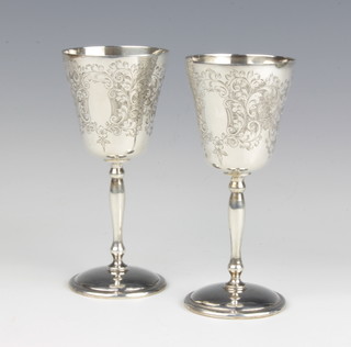 A pair of chased silver goblets with floral decoration and vacant cartouches 11.5cm, 163 grams