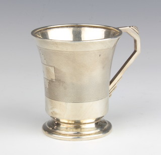 An Art Deco silver mug with engine turned decoration and angular handle Birmingham 1937 8cm, 86 grams 