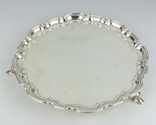 A silver salver with Chippendale rim on hoof feet Sheffield 1956, 25cm, 405 grams