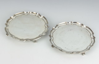 A pair of silver card trays with Chippendale rims on scroll feet, Sheffield 1938 by James Dixon and Sons, 15.5cm, 372 grams 