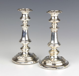 A pair of silver plated candlesticks with vase stems decorated with flowers 20cm 