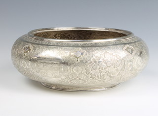 An early 20th Century Persian repousse silver shallow bowl decorated with panels of animals, birds and a pavilion 655 grams, 22cm 