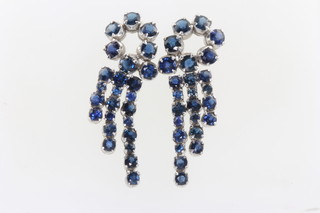 A pair of vintage rhodium plated silver, blue gem set whorl earrings containing 25 brilliant cut stones each, 40 mm x 15mm 