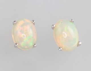 A pair of silver mounted Ethiopian opal studs 1.2ct 