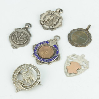 Four silver sports fobs and a badge 48 grams