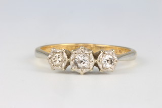An 18ct yellow gold 3 stone diamond ring size M, 2 grams