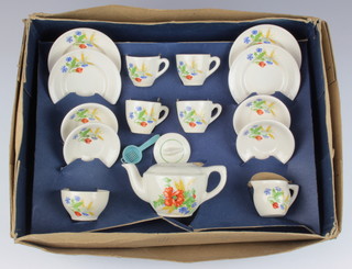 A child's 1930's tea set comprising teapot, milk jug, 4 tea cups, 4 saucers, sugar bowl, 4 side plates, decorated with flowers, boxed
