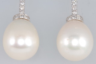 A pair of 18ct white gold pearl and diamond drop earrings 