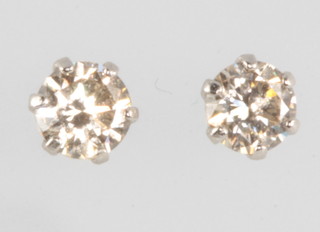 A pair of platinum single stone diamond ear studs, 0.3ct