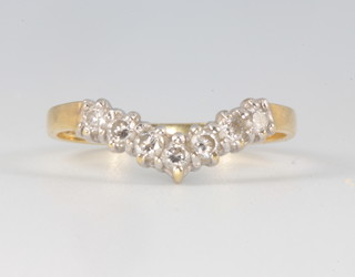 An 18ct yellow gold diamond wishbone ring size K, 0.7 grams