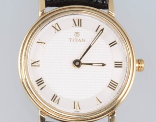 A lady's 14ct yellow gold Titan quartz wristwatch on a leather strap 