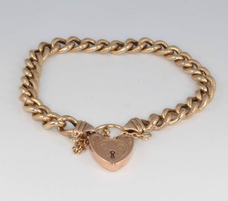 A 9ct yellow gold engraved curb link bracelet with padlock, 12.8 grams
