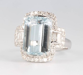 An 18ct white gold aquamarine and diamond dress ring, the emerald cut stone approx. 7.29ct surrounded by baguette diamonds 0.19ct and brilliant cut diamonds 0.57ct, size N  