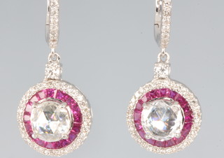 A pair of 18ct yellow gold ruby and diamond earrings, the centre diamonds approx 1.01ct each, surrounded by rubies approx 1.65ct and brilliant cut diamonds 0.6ct 