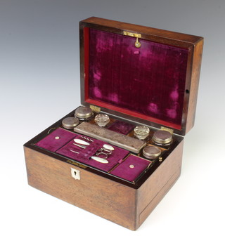 A Victorian mahogany work box with base drawer, containing glass jars with silver plated mounts and accessories 