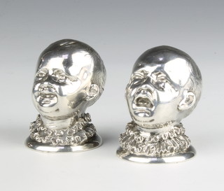 A pair of Victorian cast silver novelty condiments in the form of 2 boys with ruff collars, London 1882, maker James Barclay Hennell, 4.5cm, 132 grams