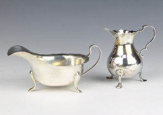A silver sauce boat on pad feet Sheffield 1947 and a Georgian silver baluster cream jug 185 grams