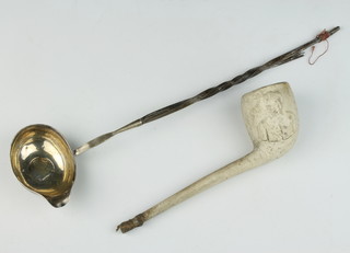 An 18th Century silver coin set ladle with whalebone handle together with a clay pipe 