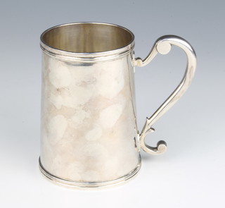 A Continental silver mug with scroll handle 12cm, 470 grams