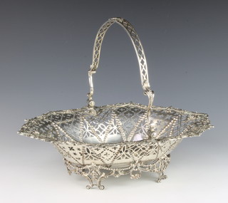 A Georgian silver pierced and cast basket with swing handle decorated with flowers and swags, raised on a pierced scroll base 38cm, 1370 grams 