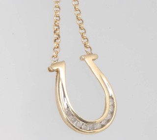 A 9ct yellow gold gem set horseshoe pendant and chain 48cm 3.5 grams gross