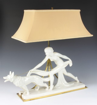 An Art Deco painted ceramic table lamp in the form of a lady with Alsatian, with gilt metal mounts, converted to electricity 74cm 