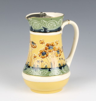 A MacIntyre Moorcroft jug decorated with flowers having a metal swing lid 17cm 
