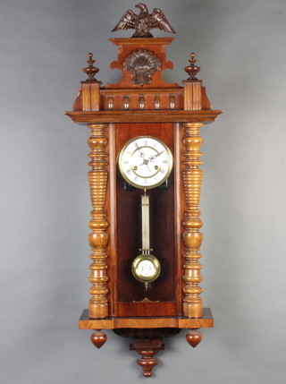 A Vienna style striking regulator with porcelain dial, Roman numerals and grid iron pendulum contained in a carved walnut case  